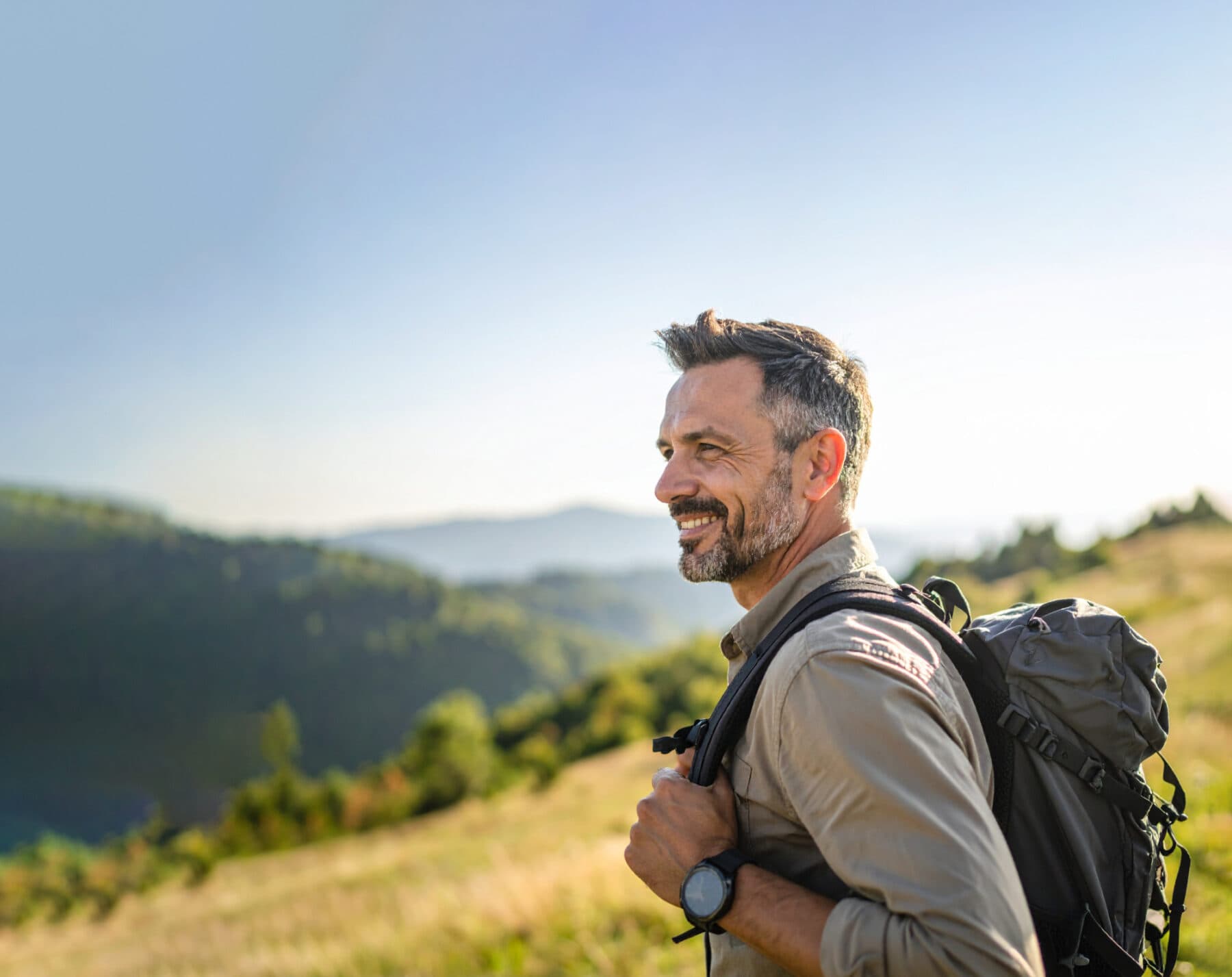 Firefly close up caucasian man in his forties hiking summer outdoors going down a hill on the 778484 copy 3